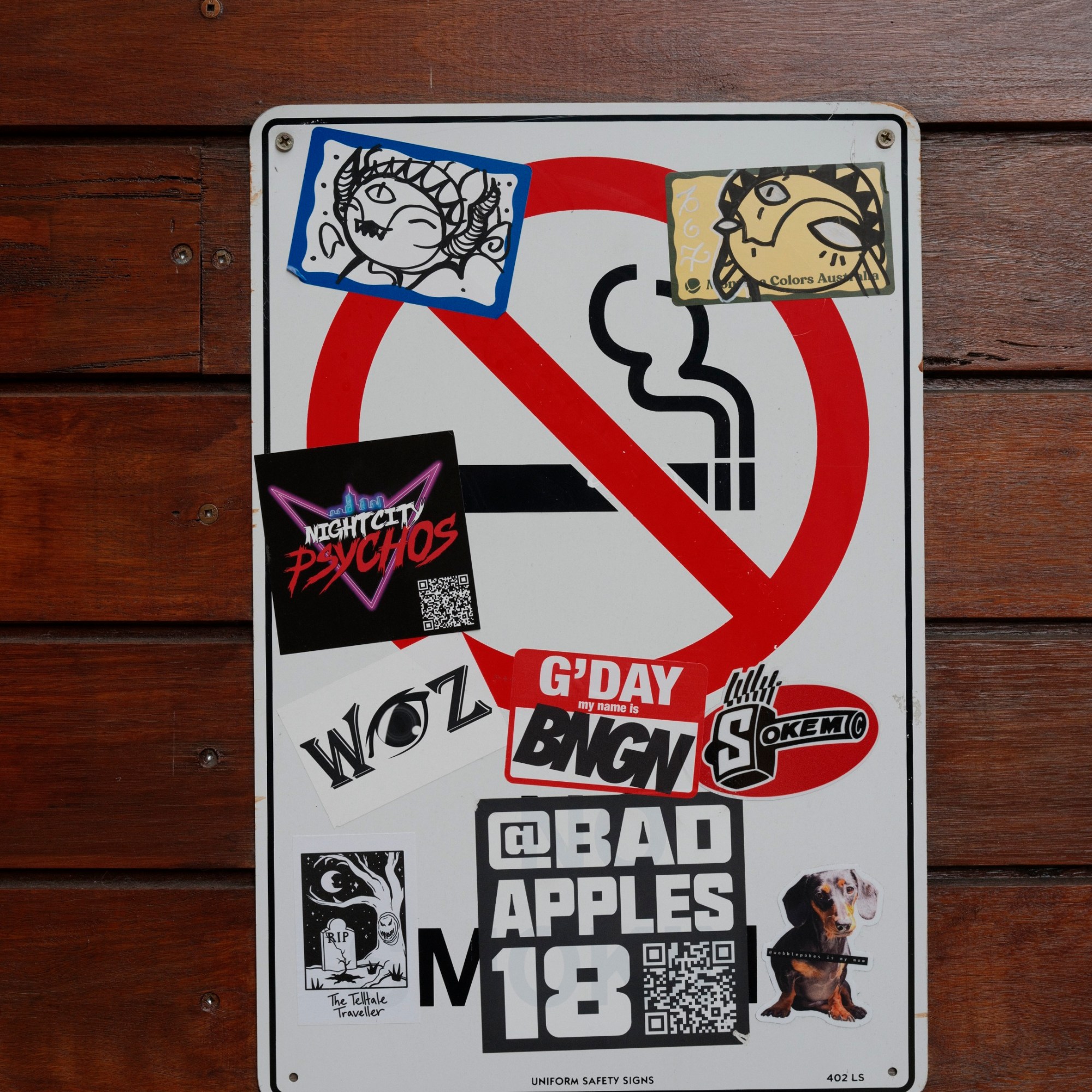 Graffitied road sign with stickers