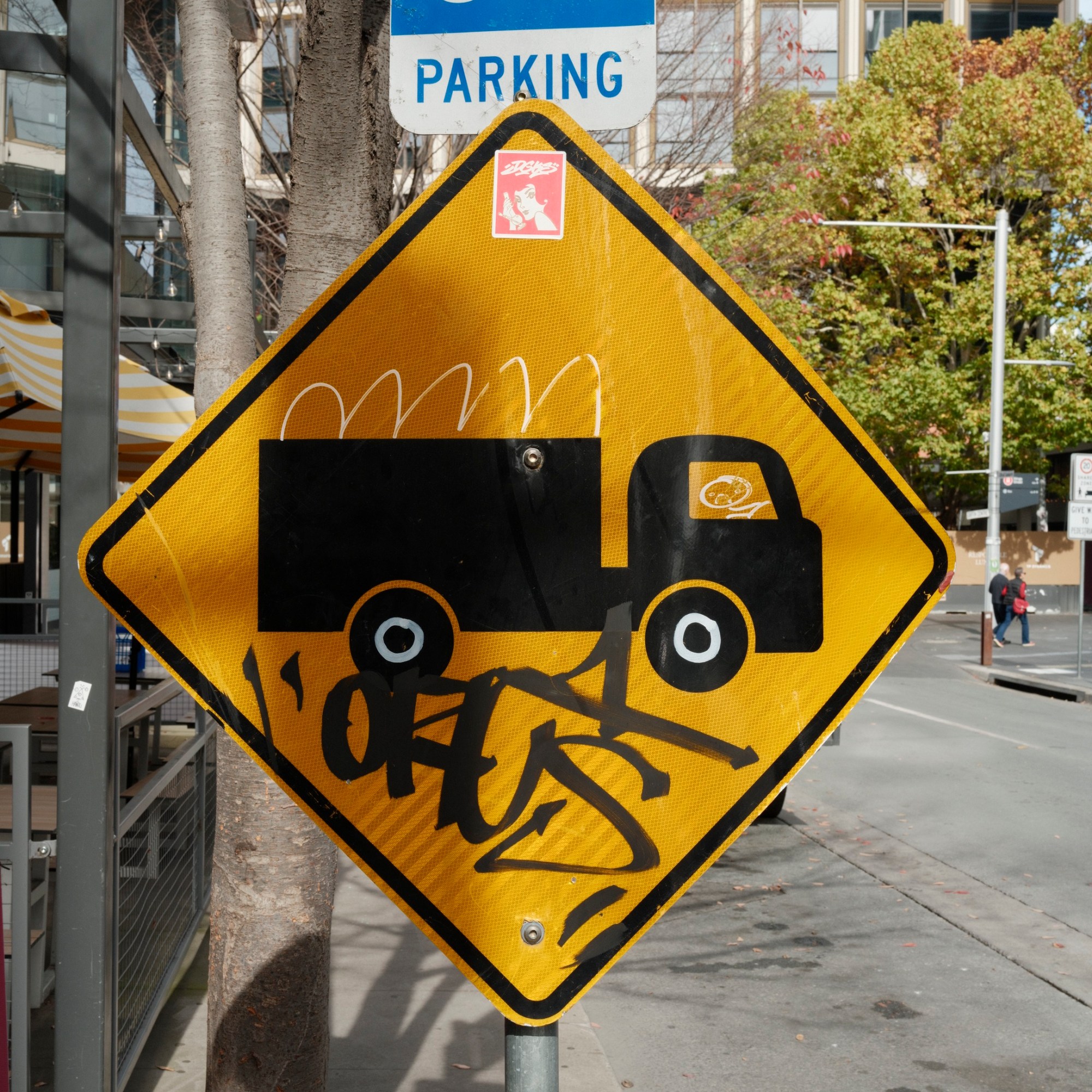 Graffitied road sign